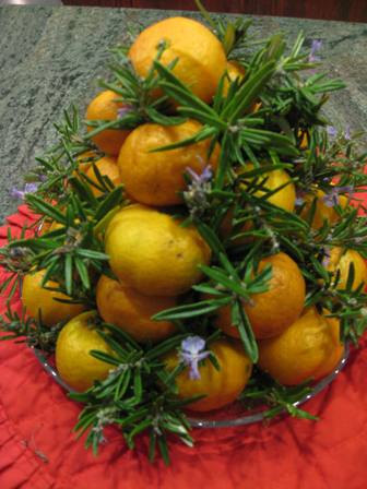 Christmas Table Decoration of Mandarin Oranges & sprigs of greenery